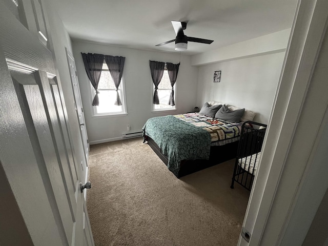 carpeted bedroom featuring baseboard heating and a ceiling fan