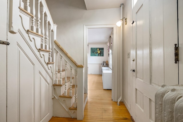 interior space with light wood-style flooring and stairs