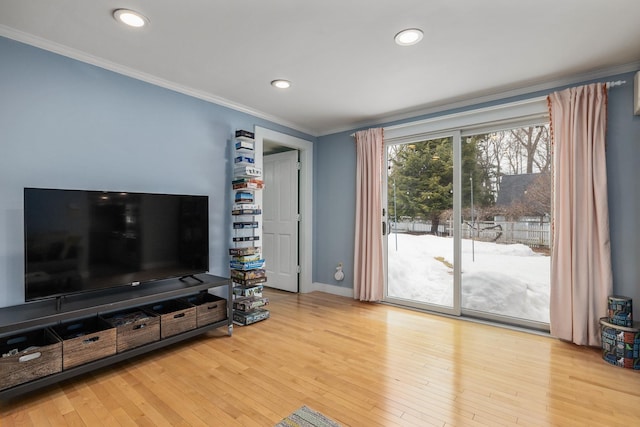 living area with hardwood / wood-style flooring, recessed lighting, crown molding, and baseboards