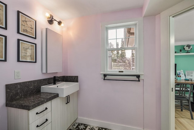 bathroom featuring a sink and baseboards