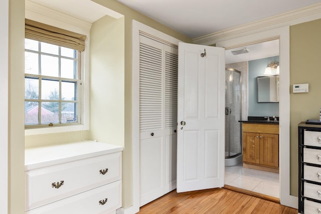 full bathroom with visible vents, a stall shower, vanity, and wood finished floors