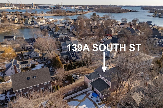 bird's eye view featuring a water view and a residential view