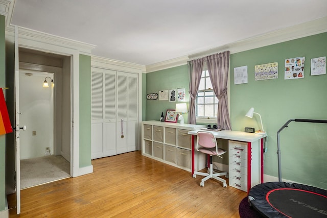 office space with light wood-style floors and crown molding