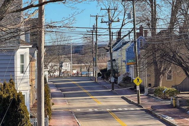 view of street featuring traffic signs, curbs, and sidewalks