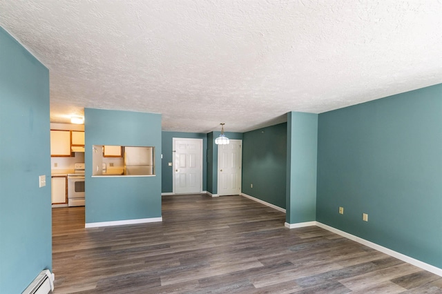 unfurnished living room with a textured ceiling, a baseboard heating unit, baseboards, and wood finished floors