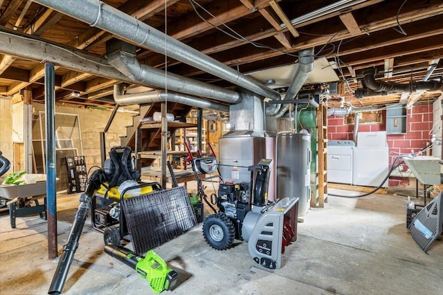 unfinished below grade area featuring washer and clothes dryer and water heater