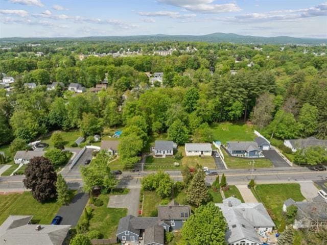 birds eye view of property with a view of trees