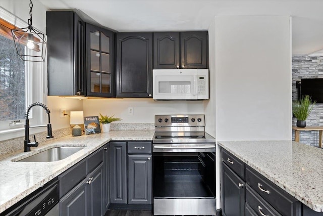 kitchen featuring a sink, glass insert cabinets, stainless steel range with electric cooktop, dishwashing machine, and white microwave