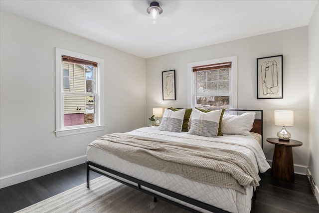 bedroom with baseboards and wood finished floors