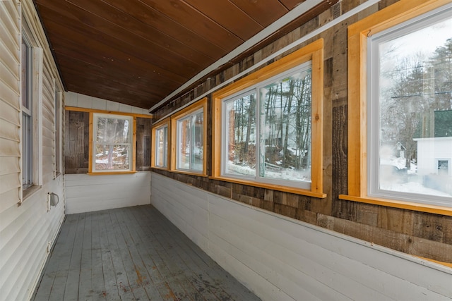 unfurnished sunroom with a wealth of natural light, wood ceiling, and lofted ceiling