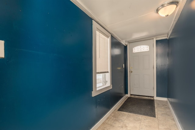 entryway with tile patterned flooring and baseboards