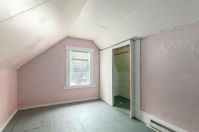 bonus room featuring lofted ceiling, light wood finished floors, and a baseboard radiator