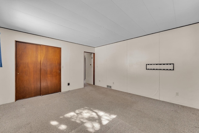 unfurnished bedroom with carpet flooring and visible vents