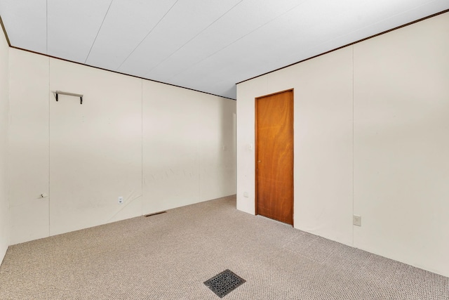 empty room featuring carpet and visible vents