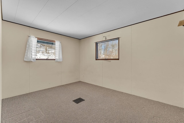 carpeted spare room with visible vents