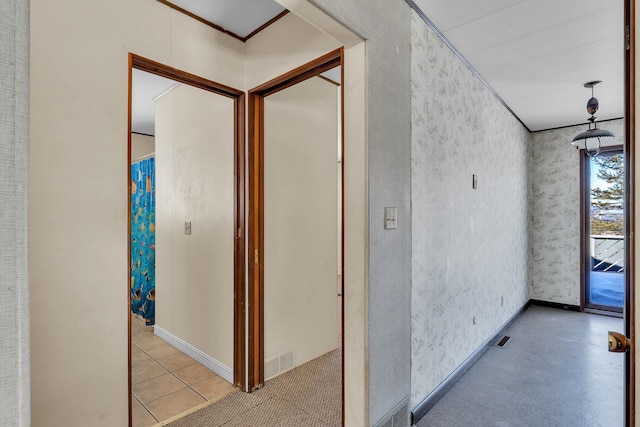 hall featuring visible vents, ornamental molding, and wallpapered walls