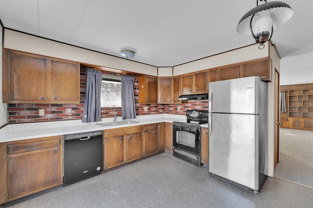 kitchen featuring under cabinet range hood, black appliances, light countertops, and a sink