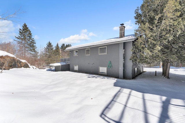 snow covered house with a chimney