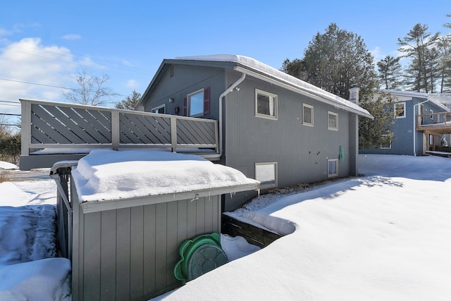 view of snow covered exterior featuring a jacuzzi