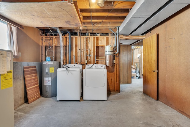 below grade area featuring washer and dryer and electric water heater