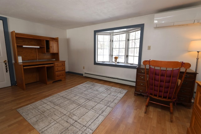 office space with a baseboard radiator, an AC wall unit, and wood finished floors