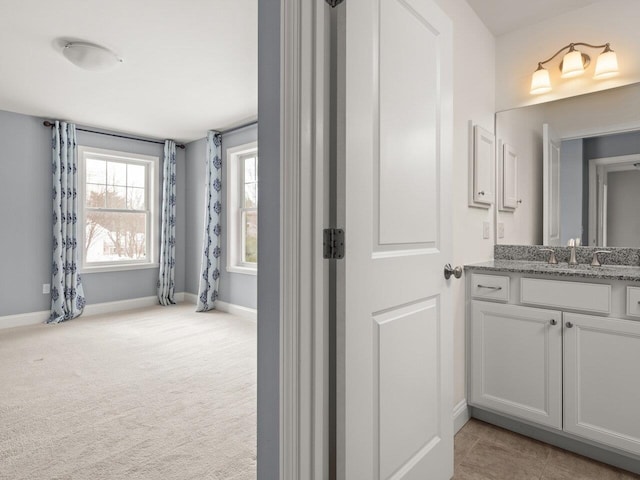 bathroom featuring baseboards and vanity