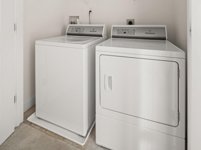 laundry room featuring laundry area, washer and dryer, and carpet floors