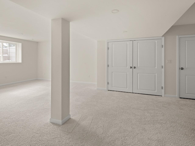 bonus room with baseboards and carpet floors