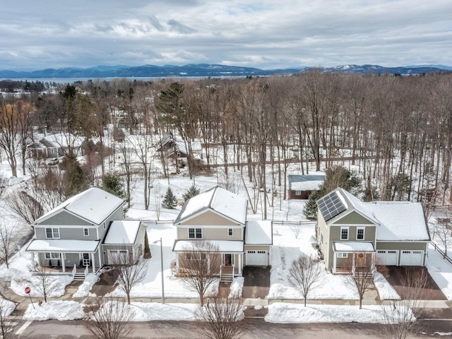 snowy aerial view with a mountain view