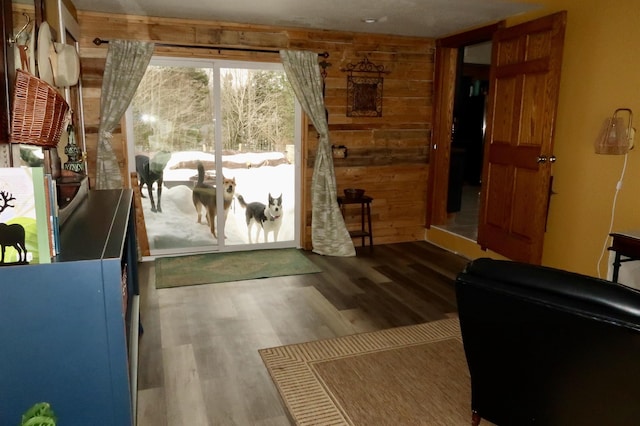 entryway with wood finished floors and wood walls