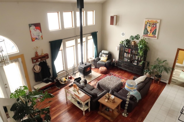 living room featuring a wealth of natural light, a high ceiling, and wood finished floors