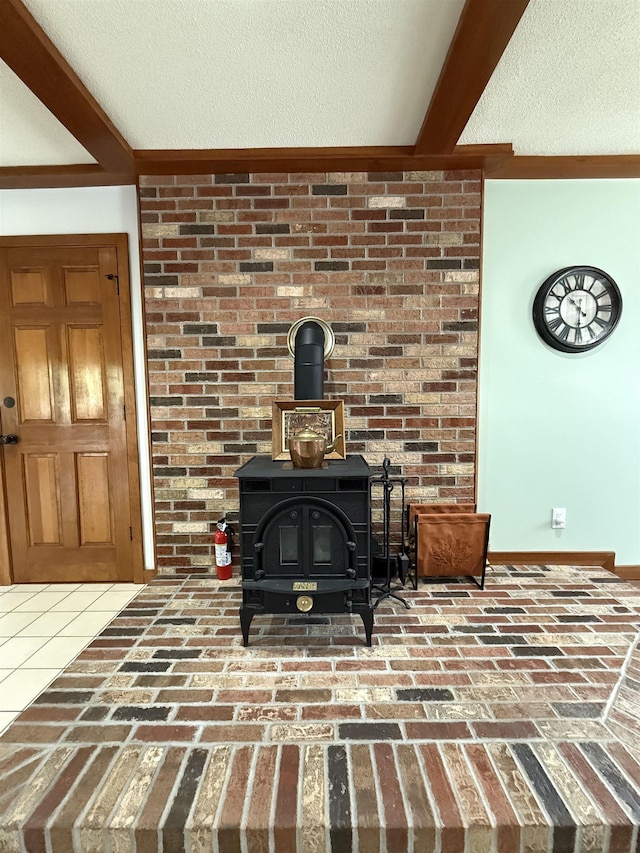 living room featuring brick floor, beam ceiling, a textured ceiling, and a wood stove