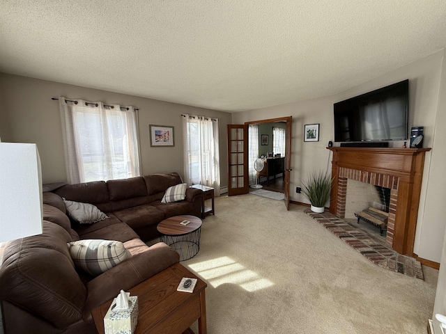 carpeted living room with a brick fireplace, a textured ceiling, and baseboards