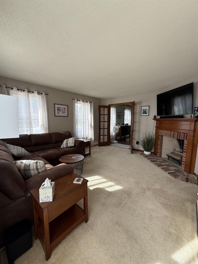 living area featuring a textured ceiling, a brick fireplace, baseboards, and light carpet