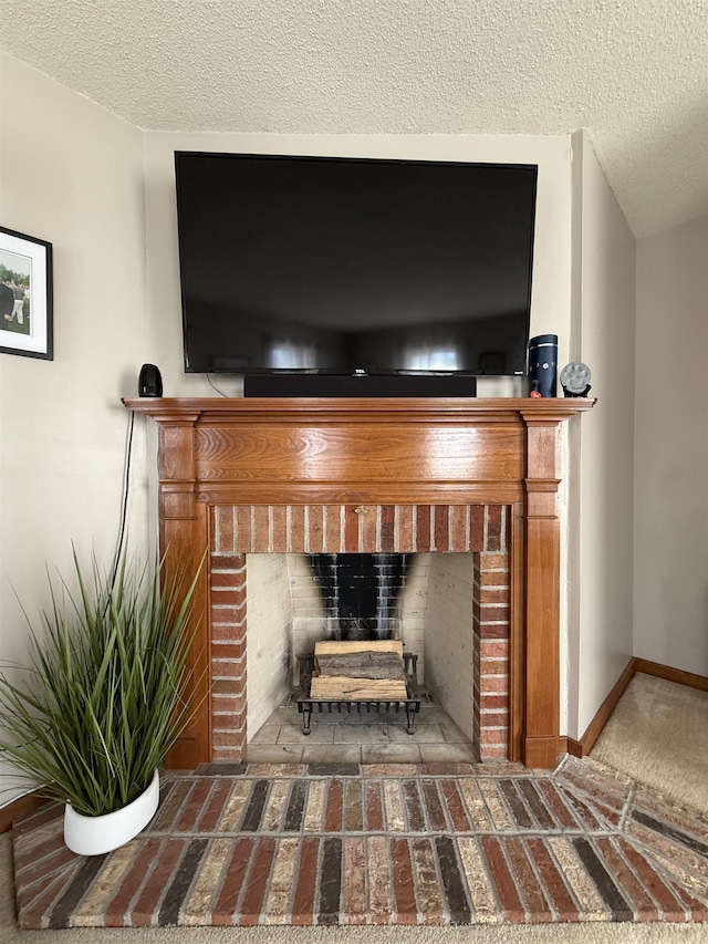 room details with a fireplace, a textured ceiling, and baseboards