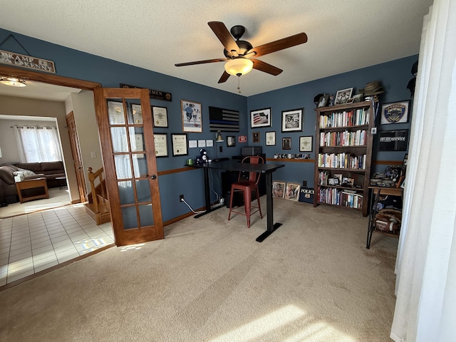 home office with french doors, a textured ceiling, ceiling fan, and carpet floors