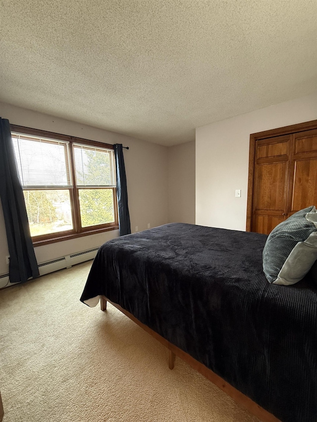 carpeted bedroom featuring a textured ceiling