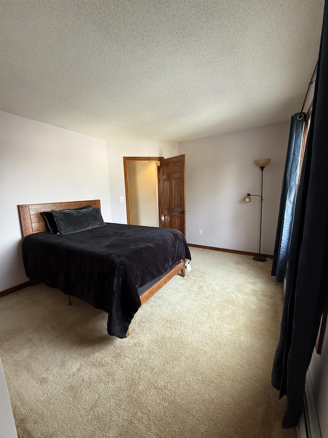 bedroom featuring baseboards, carpet, and a textured ceiling