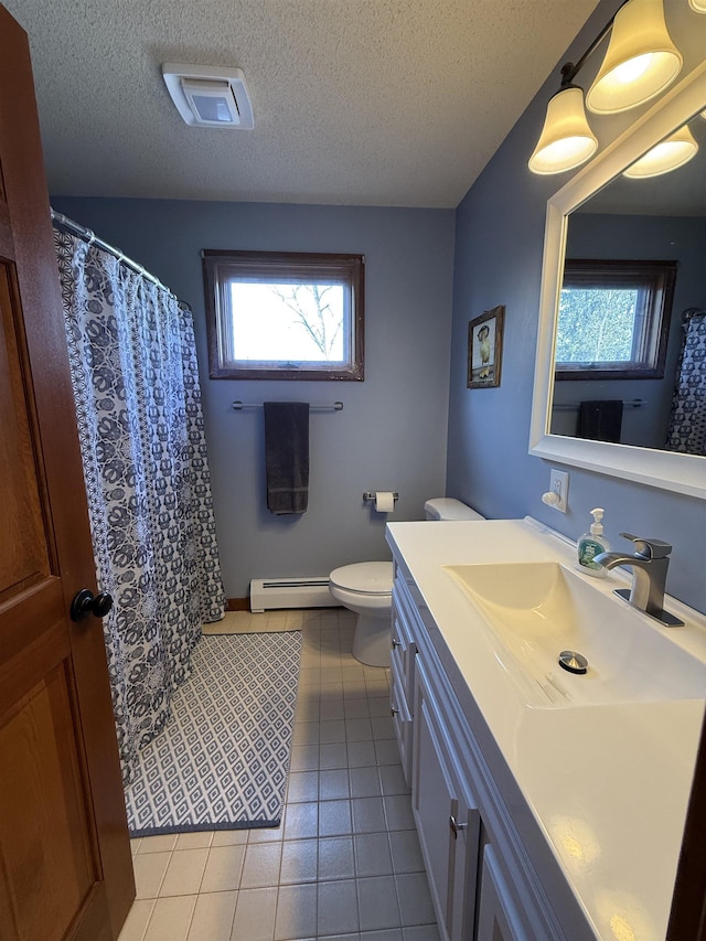 bathroom with a textured ceiling, baseboard heating, vanity, and toilet