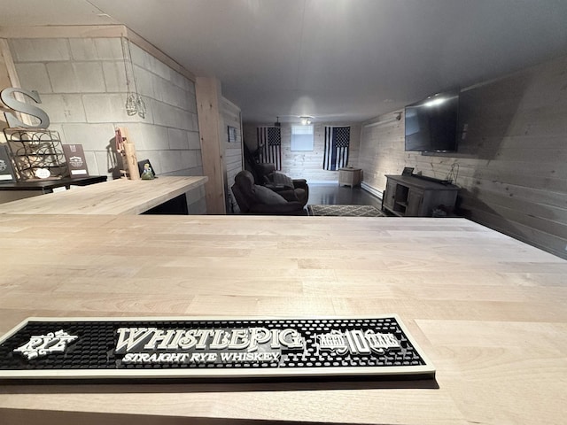 kitchen featuring light countertops and concrete block wall