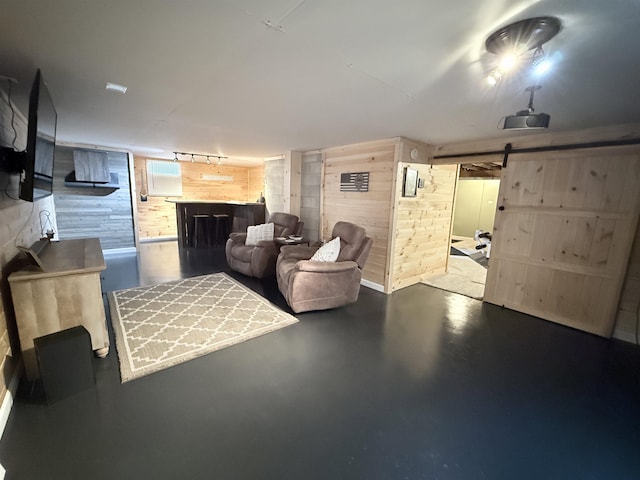 interior space with wooden walls and a barn door