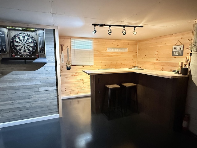 interior space with wooden walls and track lighting