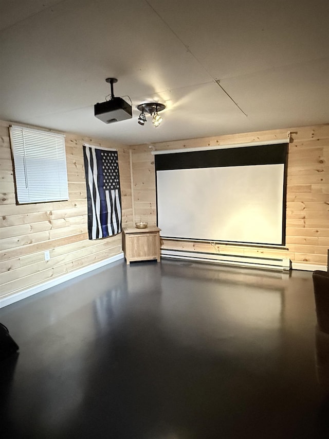 home theater with finished concrete floors and wood walls