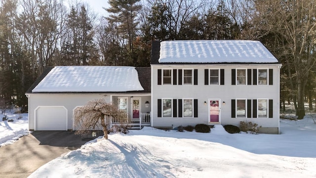 colonial-style house with driveway and a garage