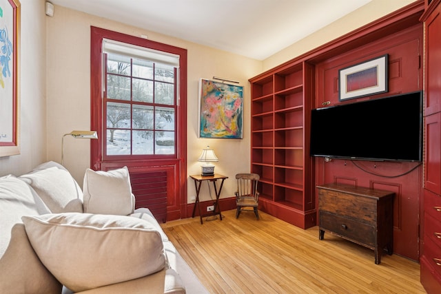 living area with light wood finished floors and baseboards