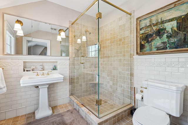 full bath with lofted ceiling, tile walls, and a shower stall