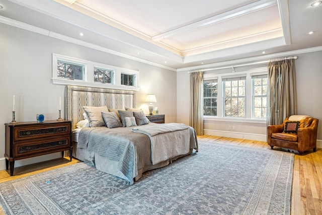 bedroom featuring hardwood / wood-style floors, baseboards, recessed lighting, crown molding, and a raised ceiling