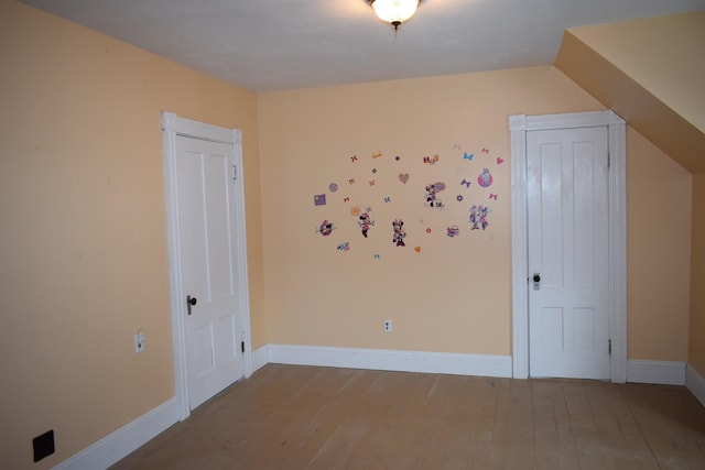 interior space featuring baseboards and wood-type flooring