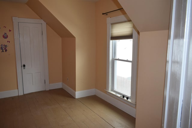 additional living space featuring light wood-style flooring and baseboards