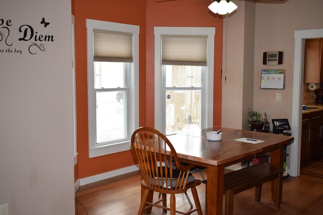 dining area featuring baseboards and light wood-style flooring